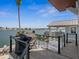 Outdoor patio with a grill, lounge chairs, and views of the beautiful waterfront at 5820 Balao S Way, St Pete Beach, FL 33706