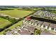 Aerial view of the property with surrounding neighborhood, lake, and green spaces at 6206 Mooring Line Cir, Apollo Beach, FL 33572