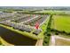 Aerial view of the property with surrounding neighborhood, lake, and green spaces at 6206 Mooring Line Cir, Apollo Beach, FL 33572