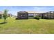 Expansive backyard featuring lush grass and a screened-in lanai at 6206 Mooring Line Cir, Apollo Beach, FL 33572