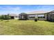 Spacious backyard with lush green lawn and screened lanai, perfect for outdoor living at 6206 Mooring Line Cir, Apollo Beach, FL 33572