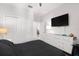This bedroom boasts a mounted TV and a white dresser with clear pulls at 6206 Mooring Line Cir, Apollo Beach, FL 33572