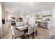 Open-concept dining area with modern lighting, stylish decor, and stainless steel appliances at 6206 Mooring Line Cir, Apollo Beach, FL 33572