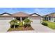 Beautiful home featuring a two-car garage, well-maintained landscaping and a cozy front porch at 6206 Mooring Line Cir, Apollo Beach, FL 33572