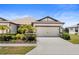 Charming single-Gathering home featuring a well-manicured lawn, two-car garage, and lush landscaping at 6206 Mooring Line Cir, Apollo Beach, FL 33572