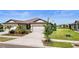 Attractive home exterior featuring a well-manicured lawn and attached garage at 6206 Mooring Line Cir, Apollo Beach, FL 33572