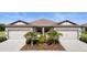 Charming exterior showcasing a well-maintained home with a two-car garage at 6206 Mooring Line Cir, Apollo Beach, FL 33572