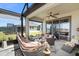 Inviting screened-in lanai with ceiling fan, stylish furniture, and peaceful backyard views at 6206 Mooring Line Cir, Apollo Beach, FL 33572