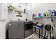 Well-organized laundry room features modern, gray appliances and stylish decor at 6206 Mooring Line Cir, Apollo Beach, FL 33572
