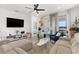 Inviting living room with comfortable seating, a ceiling fan, and sliding glass doors at 6206 Mooring Line Cir, Apollo Beach, FL 33572