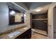 Bathroom features a double sink vanity, a granite counter, and a walk-in shower at 6438 Brentwood Dr, Zephyrhills, FL 33542