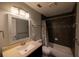 Bathroom boasts a granite vanity, large mirror, and a shower-tub combination at 6438 Brentwood Dr, Zephyrhills, FL 33542