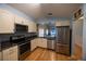 Modern kitchen with stainless steel appliances, granite countertops, and ample cabinet space at 6438 Brentwood Dr, Zephyrhills, FL 33542