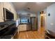 Well-lit kitchen with stainless steel appliances and a convenient breakfast bar overlooking the living room at 6438 Brentwood Dr, Zephyrhills, FL 33542