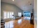 Open-concept living room with hardwood floors, sliding glass doors to the lanai, and a modern ceiling fan at 6438 Brentwood Dr, Zephyrhills, FL 33542