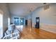 Large living room featuring hardwood floors, access to the lanai, and a calming blue color palette at 6438 Brentwood Dr, Zephyrhills, FL 33542