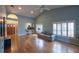 Spacious living room with vaulted ceilings, hardwood floors, and large windows providing ample light at 6438 Brentwood Dr, Zephyrhills, FL 33542