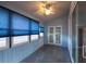 Bright sunroom with blue walls, lots of windows, and french doors to the yard at 6438 Brentwood Dr, Zephyrhills, FL 33542