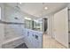 Beautiful bathroom features a tiled walk-in shower with a glass partition, rain shower head, and double sink vanity at 6440 Maiden Sea Dr, Apollo Beach, FL 33572
