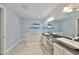 Bathroom showcasing a double sink vanity and a tiled walk-in shower with glass partition and rain shower head at 6440 Maiden Sea Dr, Apollo Beach, FL 33572