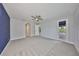 Spacious bedroom with plush carpeting and a door leading to a screened porch at 6440 Maiden Sea Dr, Apollo Beach, FL 33572