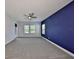 Large bedroom with plush carpeting, ceiling fan, and a window offering natural light at 6440 Maiden Sea Dr, Apollo Beach, FL 33572