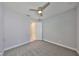 Bright bedroom with ceiling fan, grey carpet, and neutral walls at 6440 Maiden Sea Dr, Apollo Beach, FL 33572