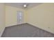 Bright, empty bedroom featuring a neutral paint scheme and carpeting at 6440 Maiden Sea Dr, Apollo Beach, FL 33572