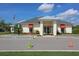 Community clubhouse with a covered entrance, American flag, and well-maintained landscaping at 6440 Maiden Sea Dr, Apollo Beach, FL 33572
