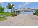 Beautiful single-story home with a paver driveway and an attached three-car garage at 6440 Maiden Sea Dr, Apollo Beach, FL 33572