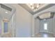 Inviting foyer with an archway, elegant lighting, and neutral paint, leading to other areas of the home at 6440 Maiden Sea Dr, Apollo Beach, FL 33572