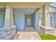 Inviting front porch featuring stone columns and a stylish front door at 6440 Maiden Sea Dr, Apollo Beach, FL 33572
