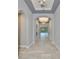 Elegant hallway with arched doorways, tile flooring, and views of the pool area at the end at 6440 Maiden Sea Dr, Apollo Beach, FL 33572