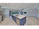 Kitchen island featuring stainless steel appliances, stone countertops, pendant lighting, and tile flooring at 6440 Maiden Sea Dr, Apollo Beach, FL 33572