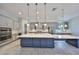 A spacious kitchen features a large center island, pendant lighting, stainless steel appliances, and white countertops at 6440 Maiden Sea Dr, Apollo Beach, FL 33572