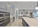 Gourmet kitchen with stainless appliances, double ovens, granite counters, and custom cabinets at 6440 Maiden Sea Dr, Apollo Beach, FL 33572