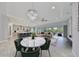 Open-concept living space with a decorative chandelier over a marble table with seating, flowing to kitchen at 6440 Maiden Sea Dr, Apollo Beach, FL 33572