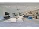 Spacious living area showcasing an open layout with modern finishes, including gray tile and stainless steel appliances at 6440 Maiden Sea Dr, Apollo Beach, FL 33572