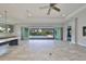 Open-concept living space with tile flooring, plenty of natural light, and access to the outdoor pool area at 6440 Maiden Sea Dr, Apollo Beach, FL 33572