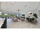 Bright, open-concept living room with modern finishes, tile floors, and a view of the outdoor pool at 6440 Maiden Sea Dr, Apollo Beach, FL 33572