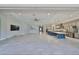 Bright living space with kitchen, ceiling fan, and sliding glass doors that connect to the outdoor area at 6440 Maiden Sea Dr, Apollo Beach, FL 33572