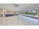 Open living area with kitchen island, tile floors, and sliding glass doors that connect to the outdoor area at 6440 Maiden Sea Dr, Apollo Beach, FL 33572