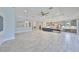 Open floor plan featuring tile flooring, ceiling fan, modern kitchen and plenty of natural light at 6440 Maiden Sea Dr, Apollo Beach, FL 33572