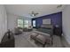 Cozy main bedroom featuring a bold accent wall, plush seating, and an inviting atmosphere with ample natural light at 6440 Maiden Sea Dr, Apollo Beach, FL 33572