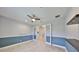 Office space featuring glass door entry, modern fan, wood look floors and decorator paint at 6440 Maiden Sea Dr, Apollo Beach, FL 33572