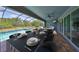 Covered patio featuring dining area with pool view, creating an ideal spot for entertaining or enjoying outdoor meals at 6440 Maiden Sea Dr, Apollo Beach, FL 33572