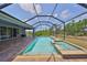 Relax in this screened lanai with a sparkling pool and spa, the perfect outdoor oasis at 6440 Maiden Sea Dr, Apollo Beach, FL 33572