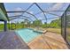 Backyard pool with a spa, brick flooring, and lush landscaping within a screened-in enclosure at 6440 Maiden Sea Dr, Apollo Beach, FL 33572