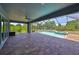 Screened-in pool area with brick flooring, ceiling fan, and ample space for outdoor furniture at 6440 Maiden Sea Dr, Apollo Beach, FL 33572