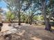 View of large backyard area with mature shade trees and fenced perimeter at 6994 Fort King Rd, Zephyrhills, FL 33541